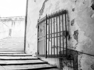 Steps with iron gate and old wall